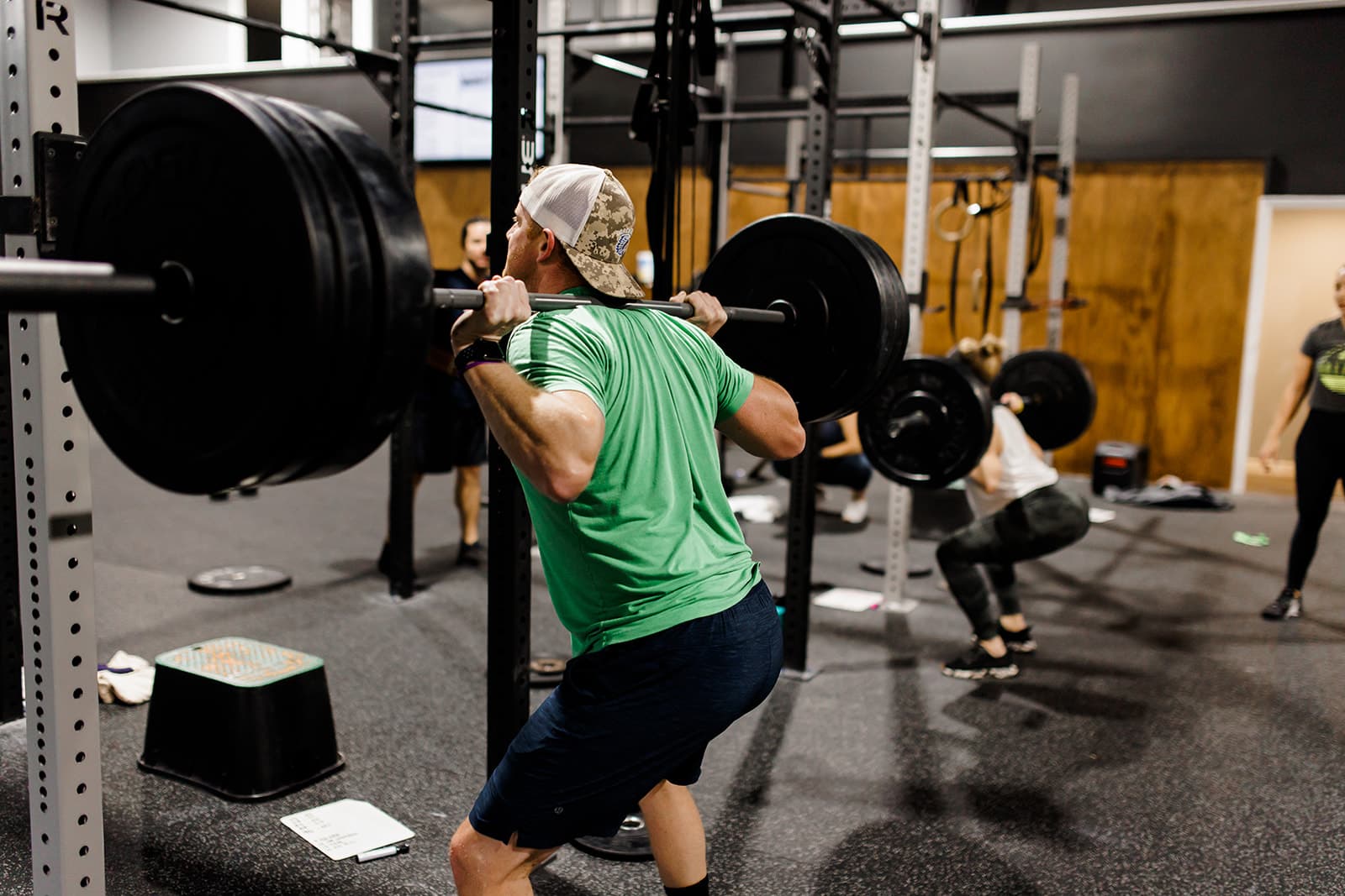 An athlete lifting a barbell during a CrossFit class